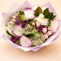 Bouquet of flowers with pink, white, and purple colors on a light background