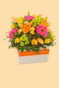 Colorful flower arrangement in a box on a beige background