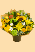 Bouquet of flowers with yellow sunflowers, greenery, and other colorful elements on a beige background