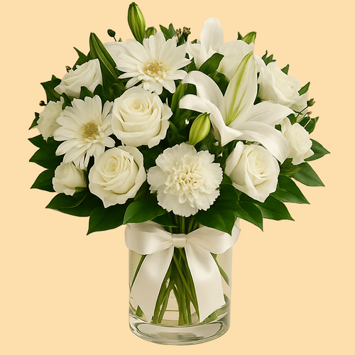 Bouquet of white flowers in a clear vase with a beige background